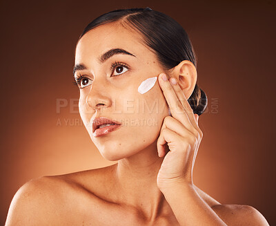 Buy stock photo Skincare, face and woman with beauty cream product for healthy facial grooming or glowing skin in studio background. Cosmetics, dermatology or girl model applying natural sunscreen lotion with mockup