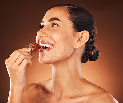 Buy stock photo Beauty, skin and skincare, woman with strawberry in healthy, vegan and clean cosmetics product, facial and natural treatment against studio background. Fruit, wellness and organic make up advertising