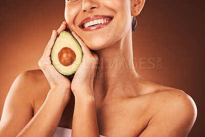 Buy stock photo Health, avocado and happy skincare woman with satisfied smile for aesthetic, beauty and youth. Happiness, body care and natural cosmetic lifestyle model holding fruit in brown studio.

