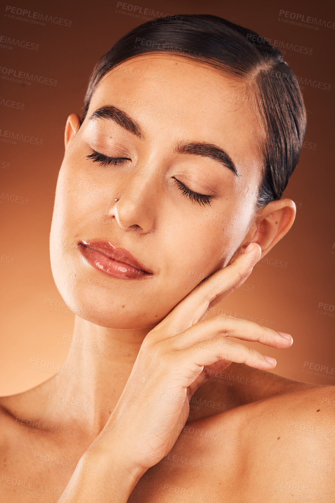 Buy stock photo Skincare, facial and hands of woman on face in studio for beauty, makeup and hygiene wellness on orange background. Hand, girl and model in India for cosmetic, product and smooth skin care mock up