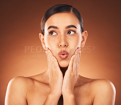 Buy stock photo Beauty, skincare and woman in a studio with a natural, health and wellness face treatment. Self care, pout and female model from Mexico with facial skin routine isolated by gradient brown background.