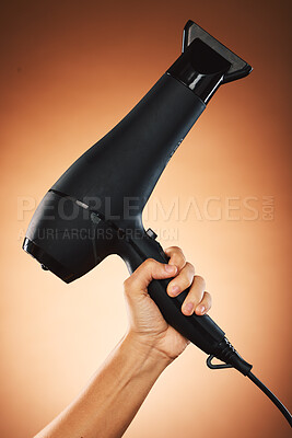 Buy stock photo Hair, hand with hair dryer and hair care with beauty and cosmetic advertising against orange studio background. Salon, hairdressing and hairstyle tool or appliance with cosmetics marketing.