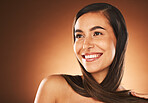 Face, beauty and hair with a model woman in studio on a brown background thinking about keratin treatment with mockup. Haircare, cosmetics and idea with a young female posing to promote hair care