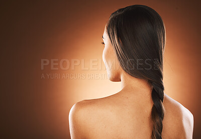 Buy stock photo Woman, back or hair style on orange background in studio in keratin treatment marketing, balayage growth advertising or self care routine. Model, texture or healthy brunette color on aesthetic mockup