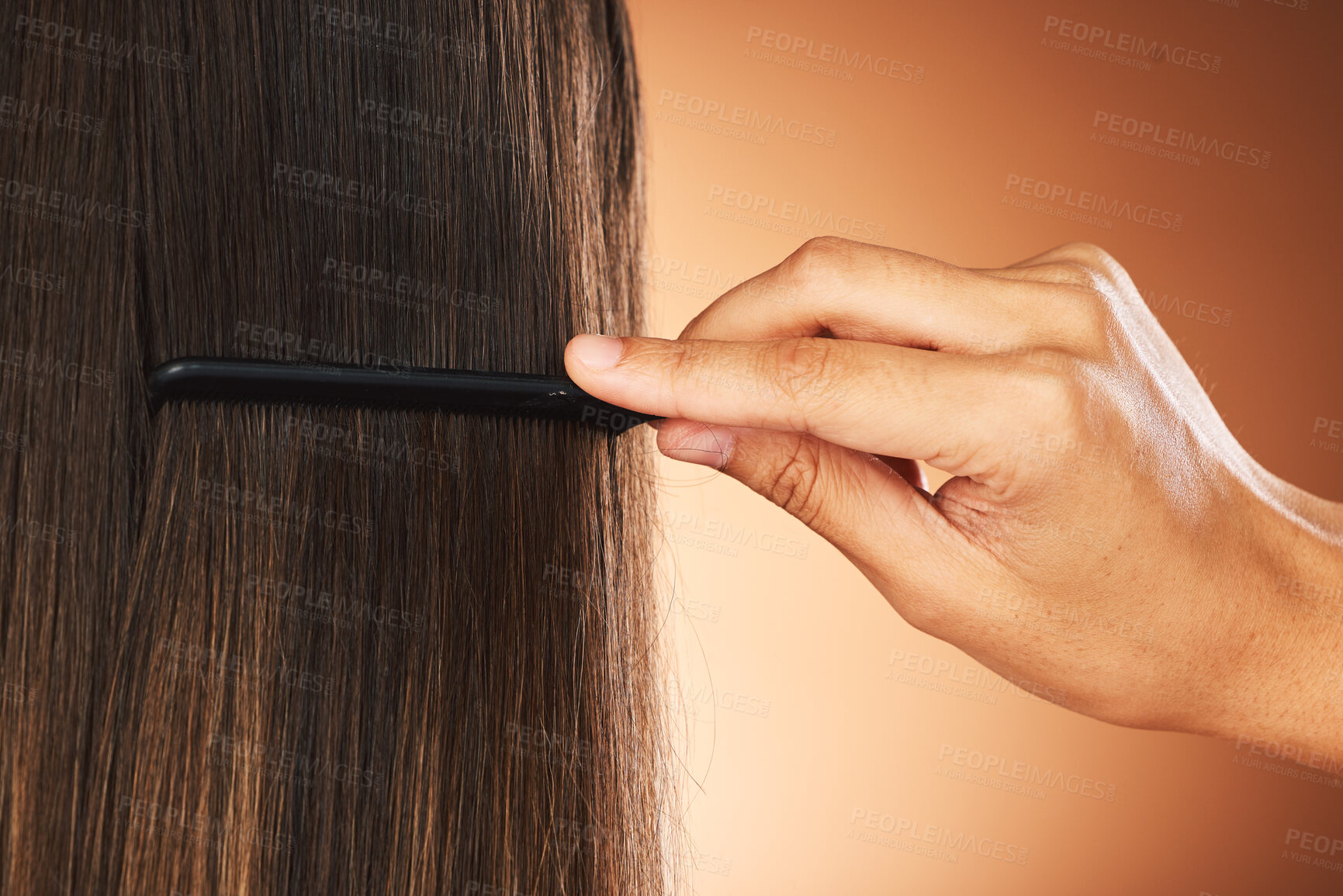 Buy stock photo Hair care, back and hand with comb for beauty, growth and grooming in a studio background with mockup. Relaxed, texture and luxury hairdresser brushing a woman or clients healthy head at salon