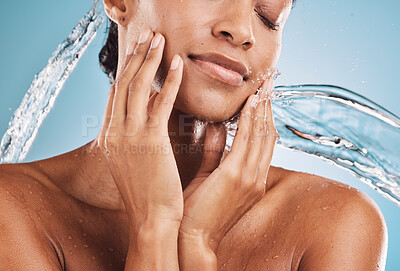 Buy stock photo Face, water and skincare black woman for beauty, cosmetics and dermatology with youth glow or shine on blue studio background. Facial water splash, skin care and young model with beauty and manicure