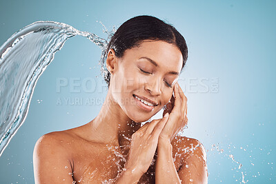 Buy stock photo Beauty, water splash and skincare, black woman on blue background in studio. Fashion, health and wellness, clean water shower on woman with healthy mindset and luxury spa treatment in South Africa.
