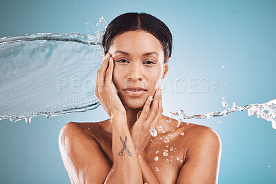 Buy stock photo Woman, beauty and water splash in skincare hydration for clean hygiene or cosmetics against a blue studio background. Portrait of female model in luxury hydrate or cleanse for perfect skin treatment