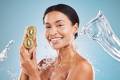Buy stock photo Beauty, water and splash, black woman with kiwi for organic cosmetic product portrait and hygiene with blue studio background. Natural, cosmetics and fruit with vitamin c for skin care and hydration.