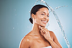 Skincare, water and black woman with splash on blue background for spa facial, cleansing and hygiene. Wellness, hydration and portrait of girl with natural beauty, cosmetics and skincare products