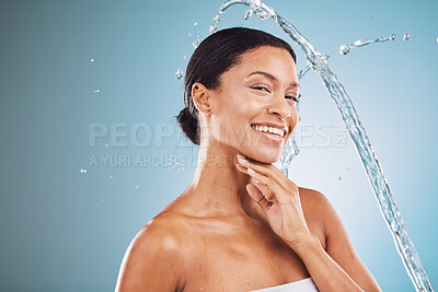 Buy stock photo Skincare, water and black woman with splash on blue background for spa facial, cleansing and hygiene. Wellness, hydration and portrait of girl with natural beauty, cosmetics and skincare products
