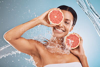 Buy stock photo Water, skincare and grapefruit with a model black woman in studio on a blue background for hygiene or hydration. Face, beauty and fruit with an attractive young female posing or cleaning in a shower