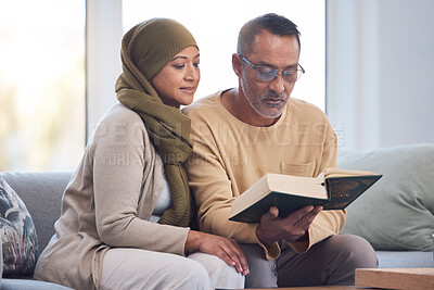 Buy stock photo Muslim couple, reading Quran and spiritual with islam, hijab and book for faith, trust and learning scripture in home. Islamic man, woman and read religious book, support and learn on  eid Mubarak