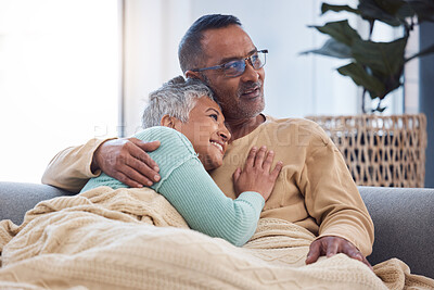 Buy stock photo Senior couple, hug and love while on living room couch thinking about future, life insurance and happiness in retirement together. Man and woman together in India home to bond, support and care