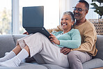 Mature couple, laptop and relax on sofa in living room, house and home on streaming subscription, online shopping and download internet media show. Happy man, woman and computer technology in lounge