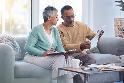 Buy stock photo Finance, documents and senior couple on sofa with bills, paperwork and insurance checklist in home, life or asset management, Elderly black people on couch with financial, retirement or mortgage debt