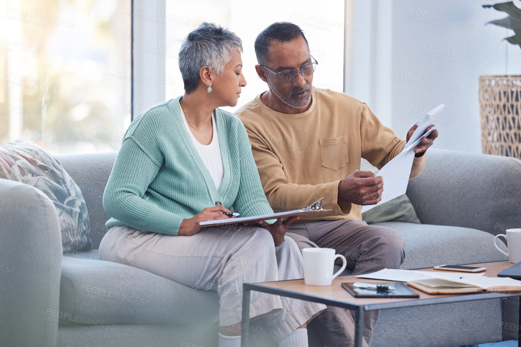 Buy stock photo Finance, documents and senior couple on sofa with bills, paperwork and insurance checklist in home, life or asset management, Elderly black people on couch with financial, retirement or mortgage debt