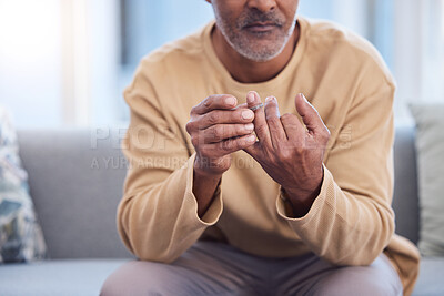 Buy stock photo Mature man, hands or touching wedding ring on sofa in house, home or marriage counseling in divorce, break up or loss. Sad, anxiety stress or mental health for widower or middle aged person with band