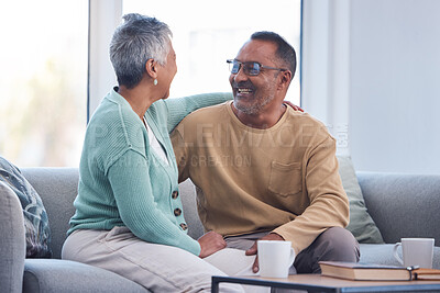 Buy stock photo Elderly couple, smile and hug laughing on sofa or relaxing and bonding time together at home. Happy man and woman relax and enjoying social conversation in love on living room couch at the house