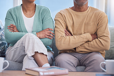 Buy stock photo Angry, upset and annoyed with a couple sitting arms crossed on a sofa in the living room of their home. Arguing, disagreement and anger with a man and woman thinking about divorce or separation