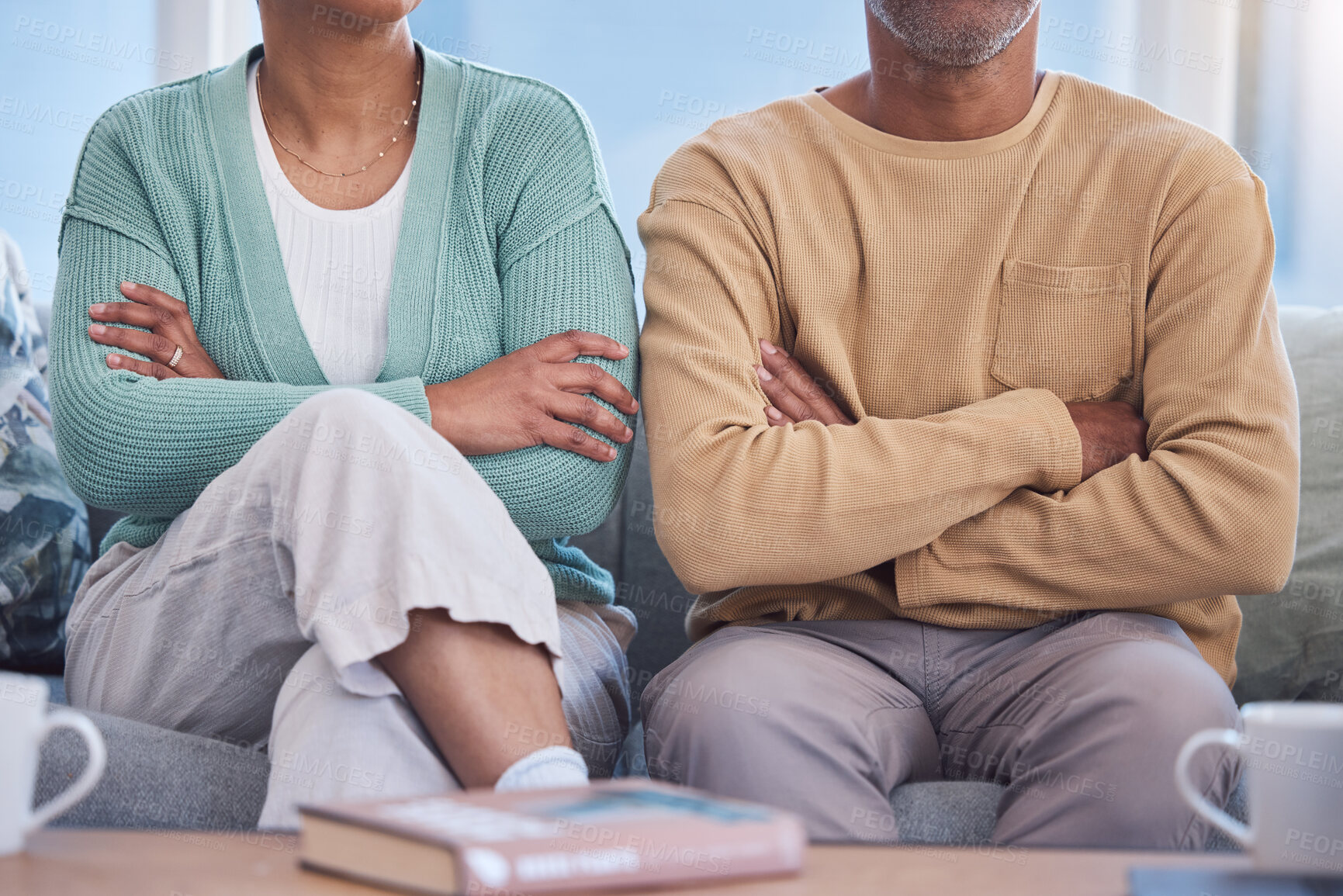 Buy stock photo Angry, upset and annoyed with a couple sitting arms crossed on a sofa in the living room of their home. Arguing, disagreement and anger with a man and woman thinking about divorce or separation