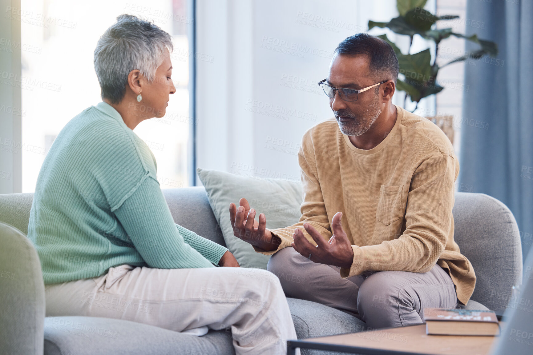 Buy stock photo Couple, talking and conversation during fight on sofa about marriage problems, conflict and communication. Divorce, argument and frustrated relationship of mature man, woman and sad partner in lounge