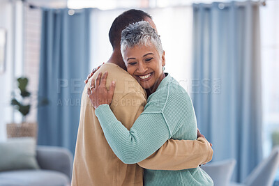 Buy stock photo Hug, love and trust with a senior couple bonding in the living room of their home together. Happy, smile and embrace with a senior man and woman hugging while enjoying retirement in their house