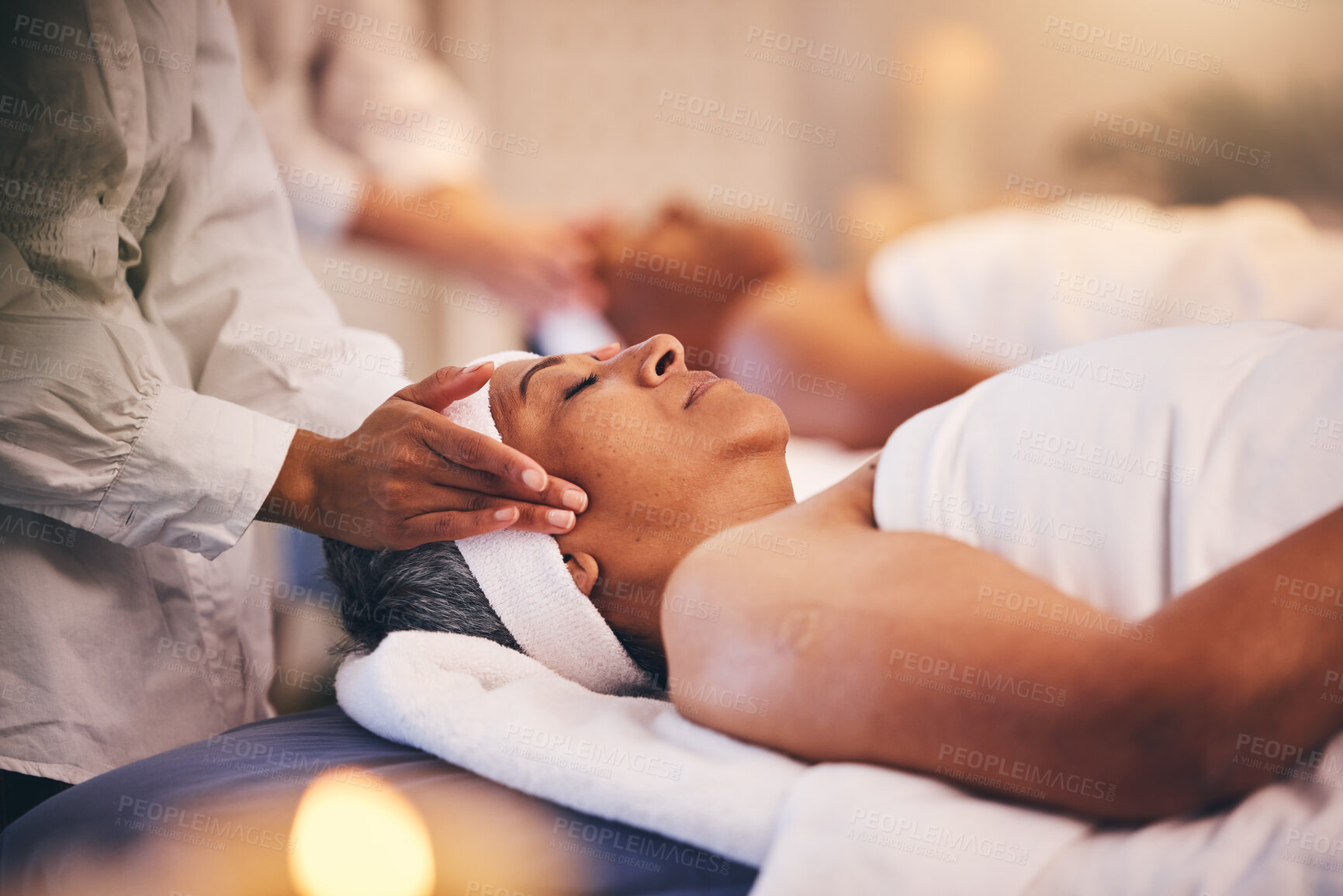 Buy stock photo Spa, massage and head of senior woman while on table to relax for calm, peace and zen time with a therapist for health and wellness. Patient get facial with cosmetics, skincare and detox treatment