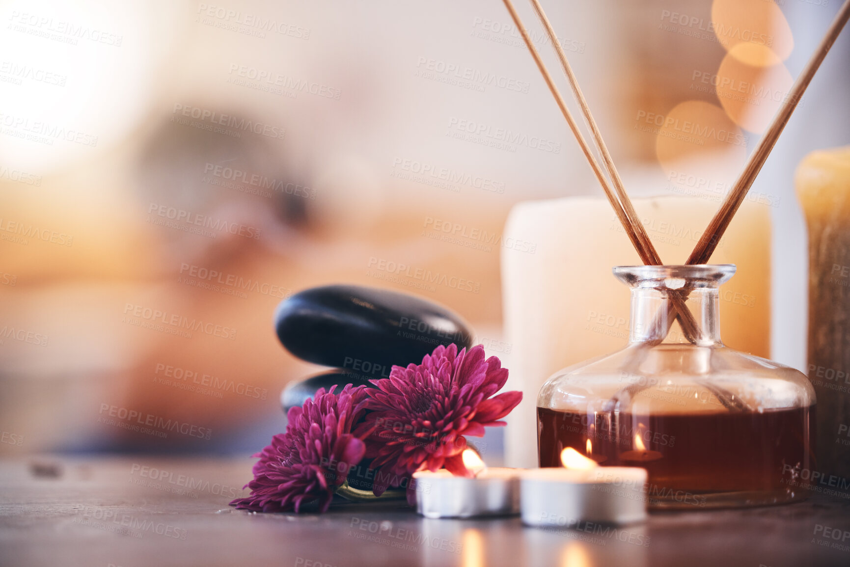 Buy stock photo Hot stones, candles and aroma oils in relax spa, hotel salon or self care retreat for healthcare wellness, massage or luxury peace. Zoom, texture and incense scent on table in beauty or empty clinic