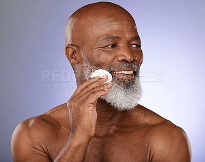 Buy stock photo Face cotton, skincare and senior black man in studio on purple background. Beauty, wellness and elderly male model from Nigeria with facial pad or product for hygiene, cleaning and grooming beard.