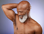 Black man, beauty and skincare with model in studio on a purple studio background for health, wellness or luxury. Senior male, cosmetics and smile with clean body while posing to promote natural care