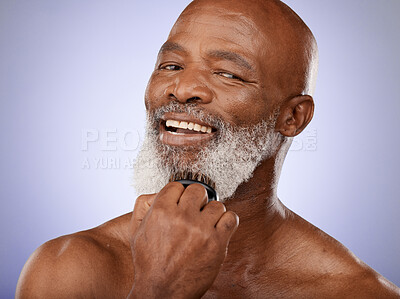 Buy stock photo Face, beauty and grooming with a model black man brushing his beard in studio on a purple background. Portrait, wellness and skincare with a handsome senior male using a brush on his facial hair
