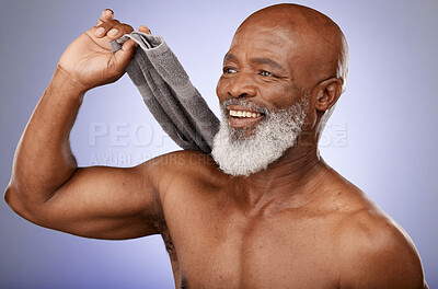 Buy stock photo Shower, hygiene and towel with a senior black man in studio on a purple background for cleaning or skincare. Health, beauty and wellness with a mature male washing in the bathroom for luxury care