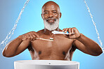 Water splash, dental and senior black man with a toothbrush and toothpaste for cleaning his teeth in studio. Face, portrait and elderly person brushing teeth or mouth on bathroom sink for self care 