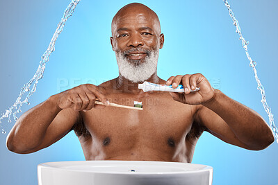 Buy stock photo Water splash, dental and senior black man with a toothbrush and toothpaste for cleaning his teeth in studio. Face, portrait and elderly person brushing teeth or mouth on bathroom sink for self care 