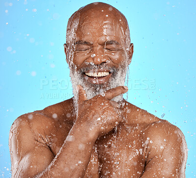 Buy stock photo Face, thinking and water splash of senior black man in studio isolated on a blue background. Skincare, hygiene and retired elderly male from Nigeria cleaning or washing for healthy skin and wellness.