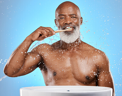 Buy stock photo Dental, brushing teeth and black man with toothbrush for teeth, cleaning with toothpaste for fresh breath and healthy gums against blue background. Water, splash and hygiene with dental care and oral