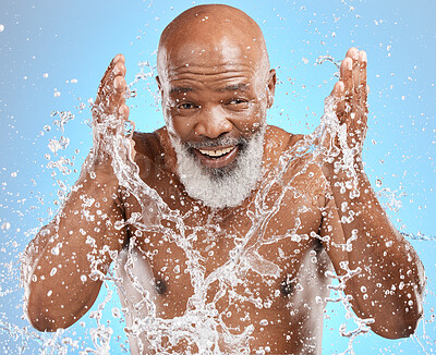 Buy stock photo Black man cleaning face, water splash and skincare with beauty, hygiene and facial care in portrait against blue background. Mature model with water, splash and skin hydration, wellness and grooming.
