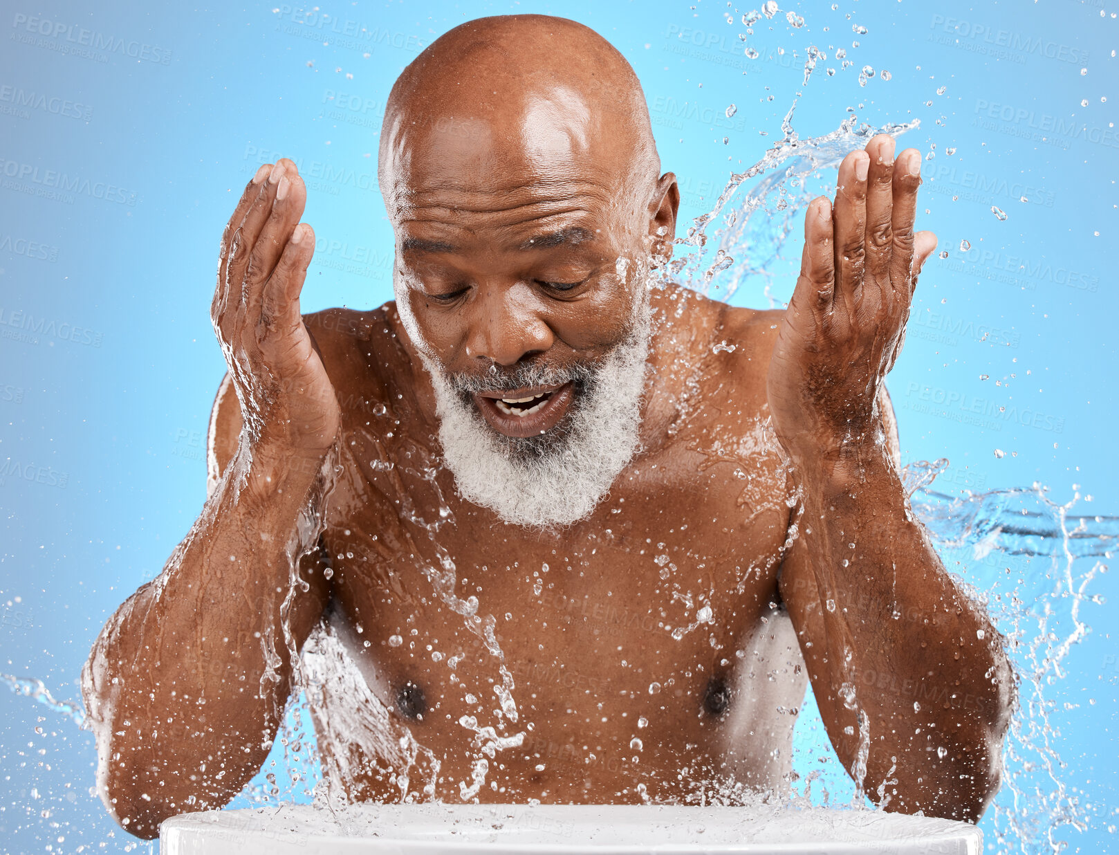 Buy stock photo Man, mature or water splash in face skincare, morning grooming routine or facial cleaning dermatology and healthcare wellness. Person washing, hygiene or self care for black model on blue background