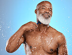Skincare, shower and senior black man in studio with happy portrait for cleaning, healthy body and water splash on blue background. Cosmetics, dermatology and aesthetic of african elderly model glow