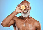 Man face, fruit and water splash in skincare grooming, Nigeria healthcare wellness or vitamin c treatment on blue background studio. Portrait, happy smile and black model lemon in mature wet cleaning