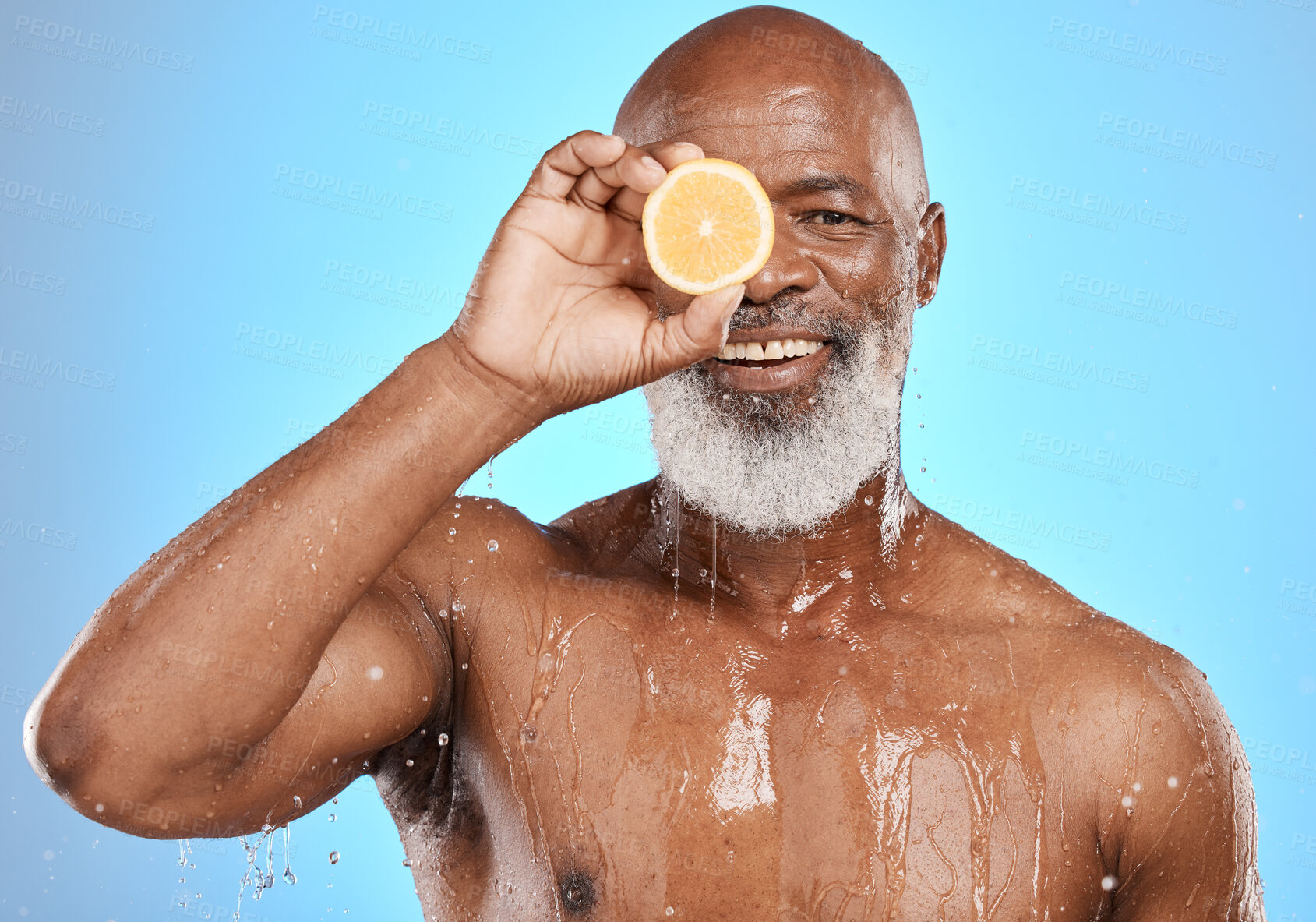 Buy stock photo Man face, fruit and water splash in skincare grooming, Nigeria healthcare wellness or vitamin c treatment on blue background studio. Portrait, happy smile and black model lemon in mature wet cleaning