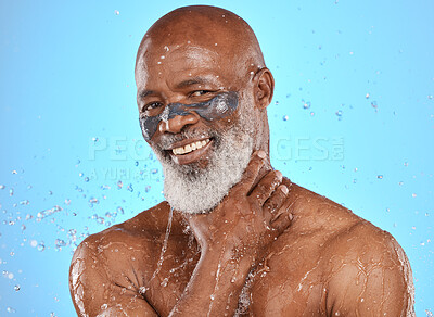 Buy stock photo Portrait, facial and senior man in studio for wellness, cleaning and skin mask with water splash on blue background. Face, elderly man and skincare mask, beauty splash and luxury product in shower 