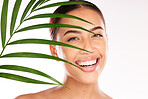 Leaf, woman and beauty, natural skincare and cosmetics from plants for wellness, glow and sustainability on studio background. Portrait of happy model face, green leaves and eco friendly dermatology