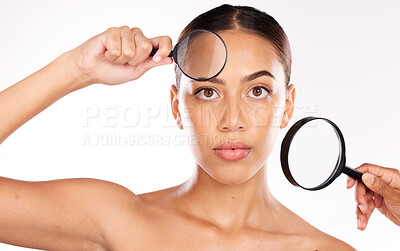 Buy stock photo Magnifying glass, beauty and woman for facial skincare, makeup cosmetics and inspection of dermatology on studio background. Portrait of young model with magnifier on face to check aesthetic wellness