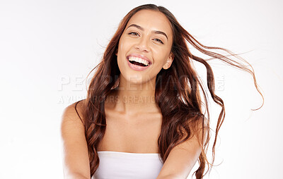 Buy stock photo Woman, face skincare and windy hair on white background in studio for keratin treatment, healthcare wellness or color dye marketing. Portrait, smile or happy beauty model with brunette waves or style