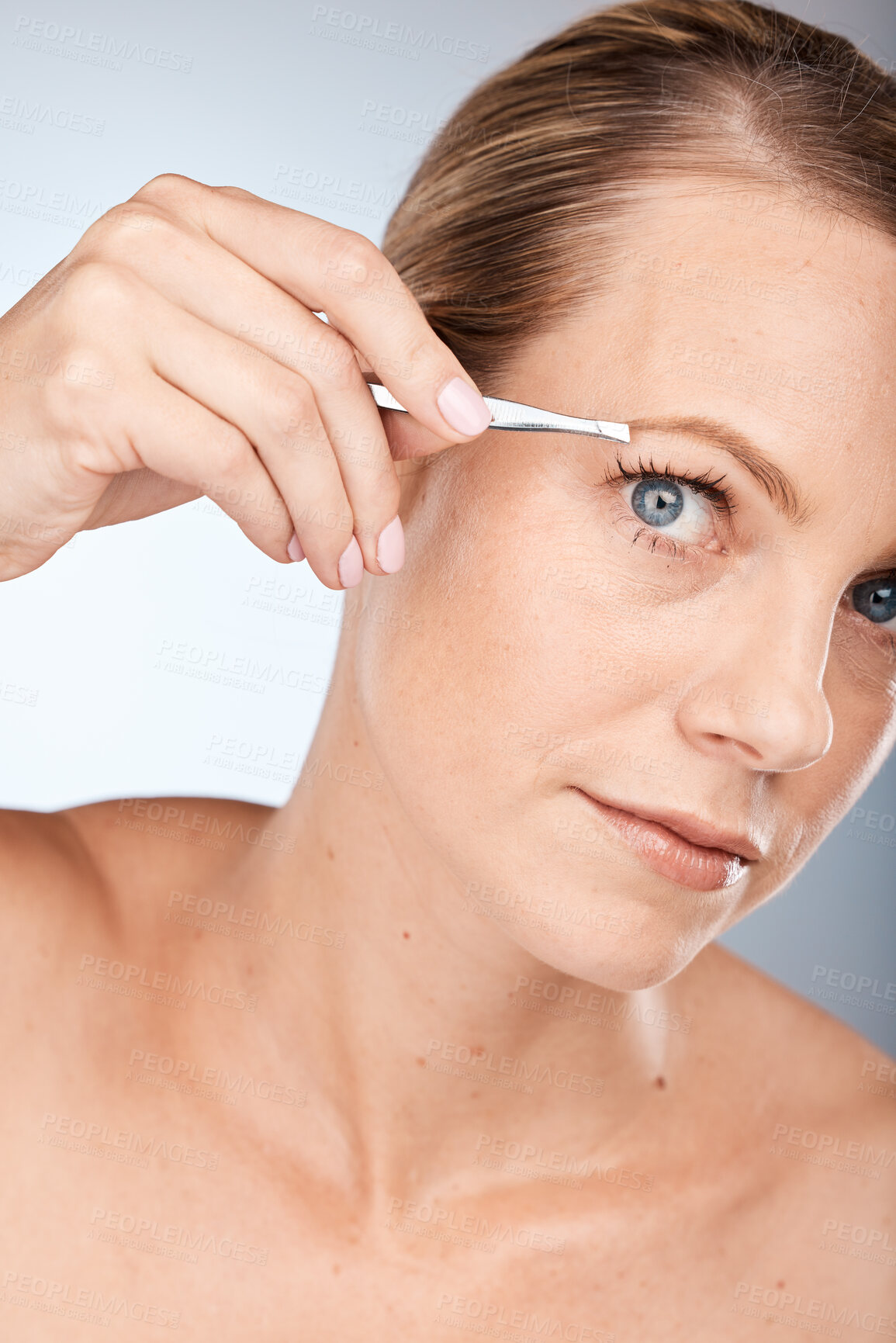 Buy stock photo Woman, face and tweezer for beauty, hair removal and epilation on a grey studio background. Aesthetic, hair care and female tweezing her eyebrow for grooming, facial and hygiene treatment 
