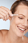 Woman, face and eyebrow hair on face with tweezers and cosmetic therapy in studio grey background. Facial, clean and makeup in beauty, natural cosmetics with tool and clean skincare with happy smile