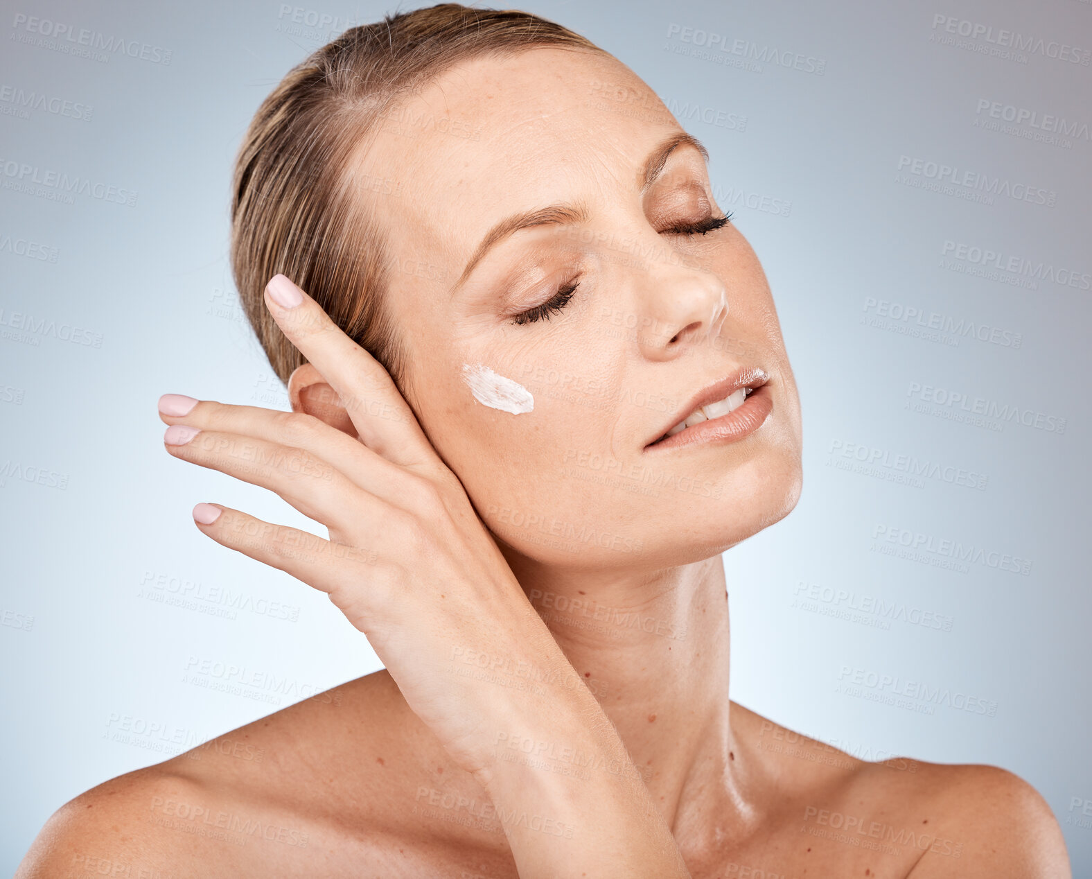 Buy stock photo Face, skincare or woman in a studio with cream for acne, anti aging or dermatology with sunscreen or mockup. Relax, product and model with facial lotion, natural makeup or foundation beauty cosmetics