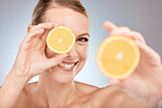 Face portrait, skincare and woman with lemon in studio isolated on a gray background. Wellness, food and happy female model holding citrus fruit for healthy diet, vitamin c or nutrition and beauty.